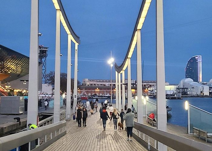 Maremagnum A group of people walking across a wooden bridge photo – Free ... photo