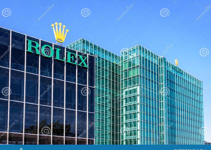 Rolex headquarters The Rolex Logo at the Top of the Headquarters Building in Geneva ... photo